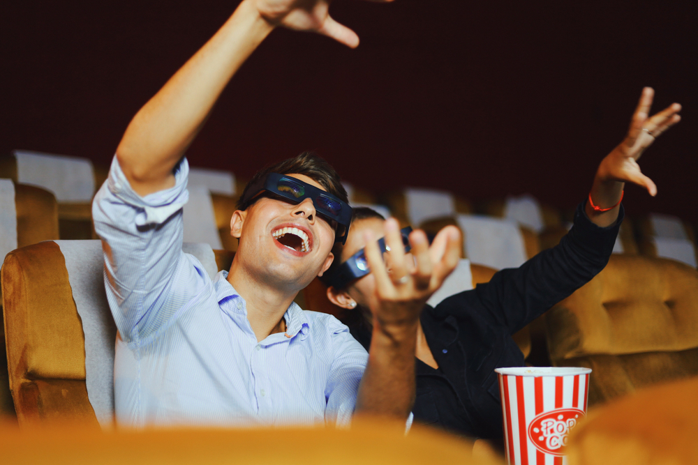 Happy Young Couple Watching 4D Movie in Cinema